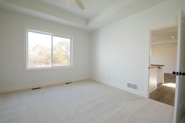 empty room featuring baseboards, ceiling fan, carpet flooring, and visible vents