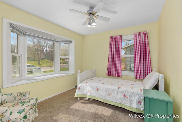 bedroom with carpet floors, a ceiling fan, and baseboards