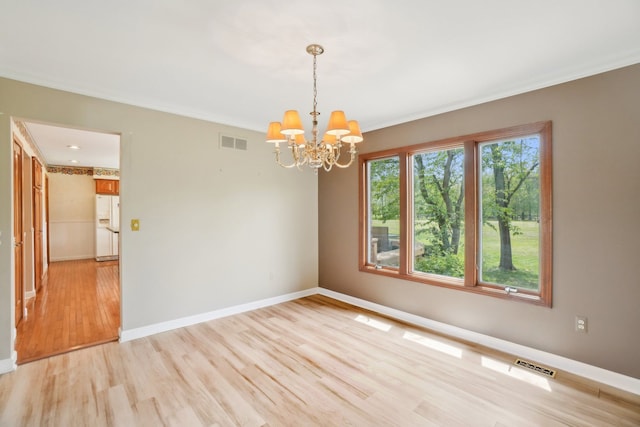 1373 Prosper Dr, Troy, MI 48098 - unfurnished room featuring light wood finished floors, a chandelier, baseboards, and crown molding