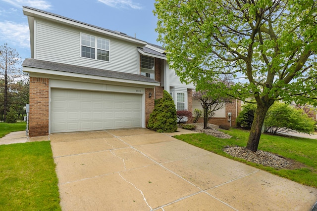 traditional-style home featuring driveway, brick siding, an attached garage, a shingled roof, and a front lawn