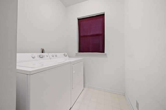 laundry area with laundry area, baseboards, and separate washer and dryer