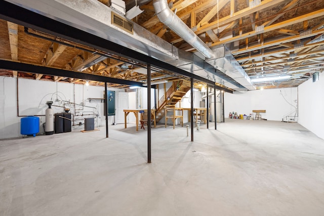 unfinished below grade area featuring stairs and visible vents