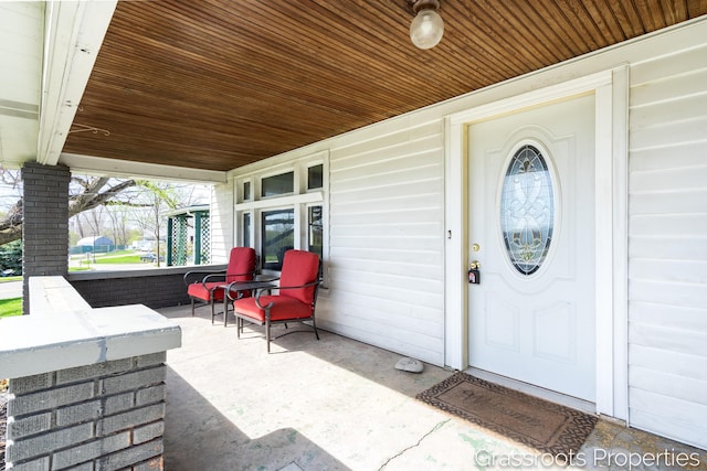 view of exterior entry with a porch