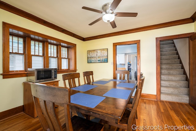 dining room with stairway, baseboards, and ornamental molding
