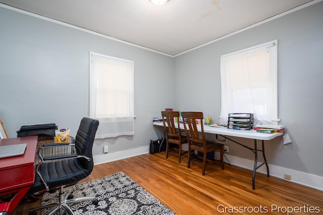 office area with crown molding, baseboards, and wood finished floors