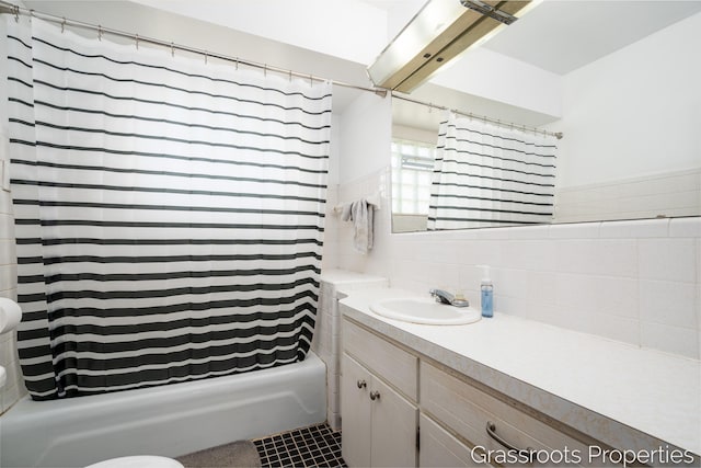 bathroom with backsplash, tile walls, shower / bath combination with curtain, and vanity