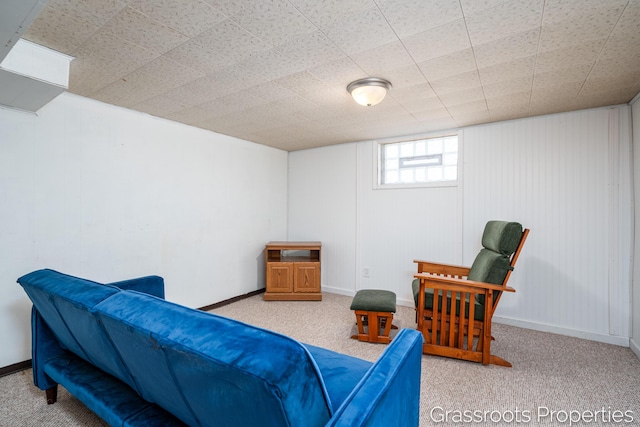 living area with baseboards and carpet flooring