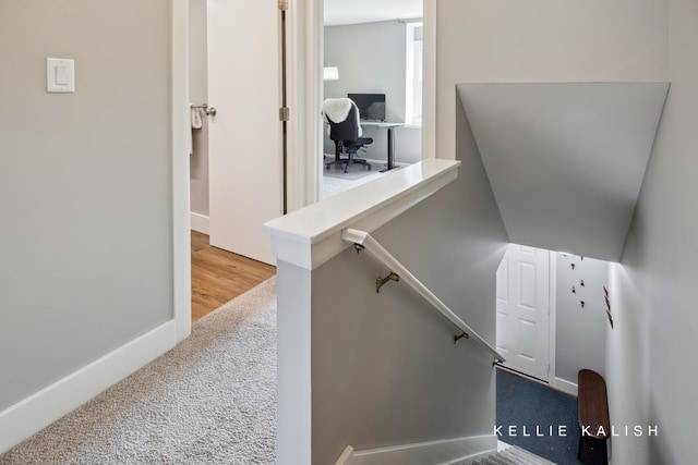 stairs with carpet floors and baseboards