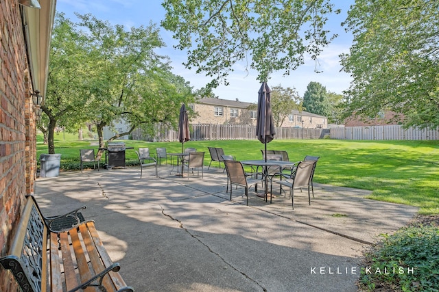 view of patio with a fenced backyard and outdoor dining area