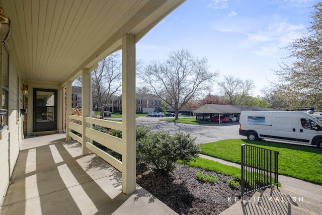 view of patio / terrace with a porch and a residential view