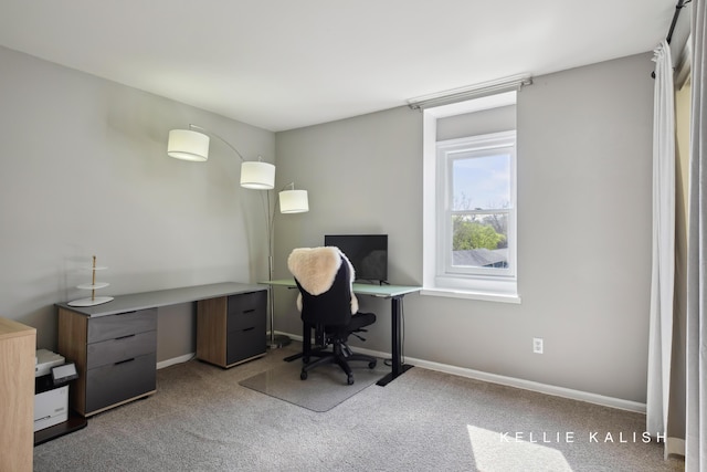 carpeted home office featuring baseboards
