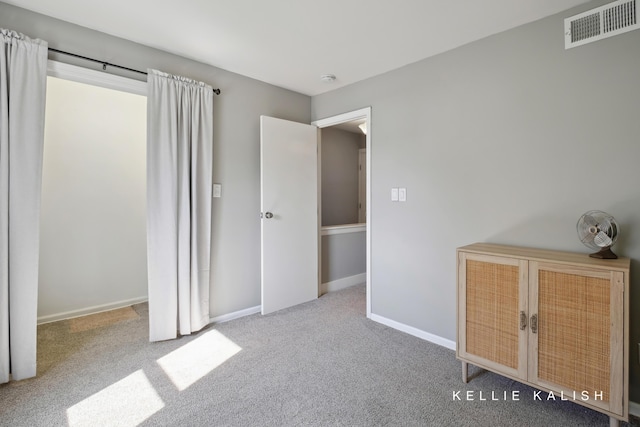 carpeted bedroom with visible vents and baseboards