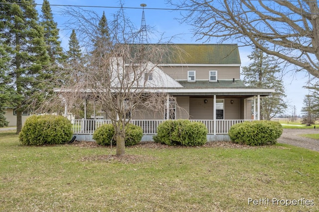 farmhouse inspired home with a porch and a front lawn