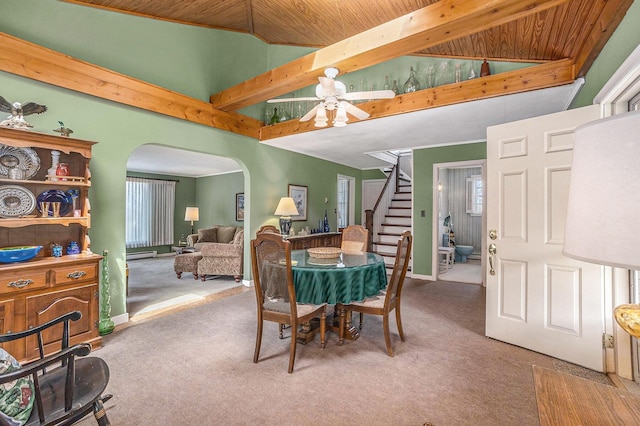 3500 N Oceana Dr, Hart, MI 49420 - dining space featuring arched walkways, ceiling fan, carpet, and stairs