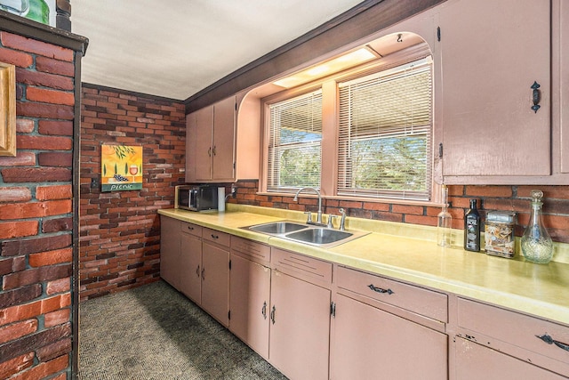 3500 N Oceana Dr, Hart, MI 49420 - kitchen featuring a sink, light countertops, and brick wall