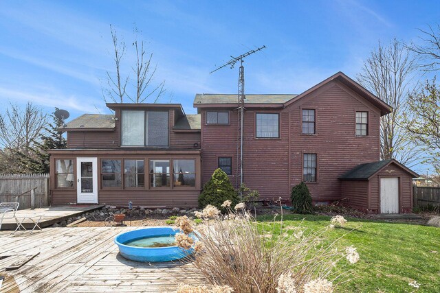 3500 N Oceana Dr, Hart, MI 49420 - rear view of house with an outdoor structure, fence, a storage shed, and a deck