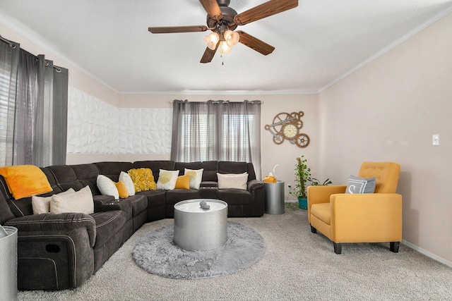 carpeted living area with a ceiling fan, baseboards, and ornamental molding