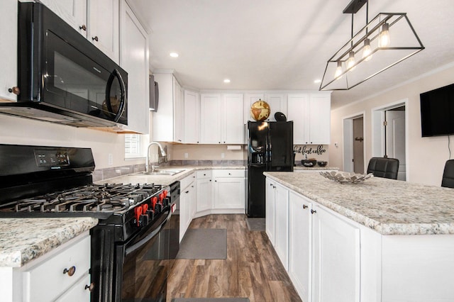 kitchen with a kitchen island, dark wood finished floors, a sink, white cabinets, and black appliances