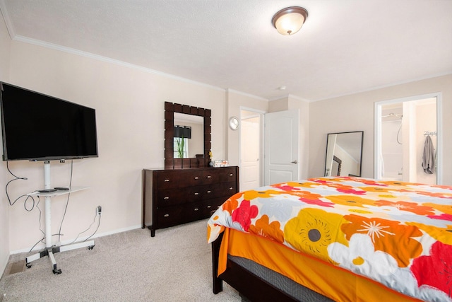 carpeted bedroom featuring crown molding and baseboards
