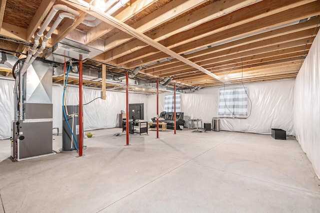 unfinished basement featuring heating unit