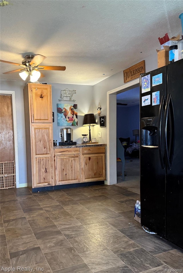 510 Maple St, Leslie, MI 49251 - kitchen featuring black fridge with ice dispenser, a ceiling fan, a textured ceiling, and dark countertops