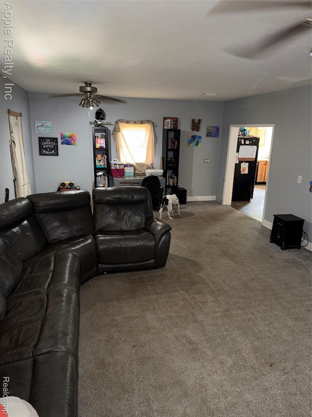 510 Maple St, Leslie, MI 49251 - carpeted living room featuring a ceiling fan and baseboards