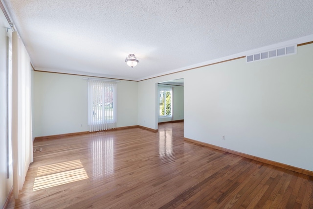 35490 Hatherly Dr, Sterling Heights, MI 48310 - spare room featuring a textured ceiling, baseboards, wood finished floors, and visible vents