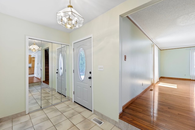35490 Hatherly Dr, Sterling Heights, MI 48310 - entrance foyer featuring baseboards, a wealth of natural light, visible vents, and a chandelier