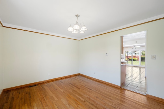 35490 Hatherly Dr, Sterling Heights, MI 48310 - unfurnished room featuring an inviting chandelier, crown molding, visible vents, baseboards, and light wood-type flooring