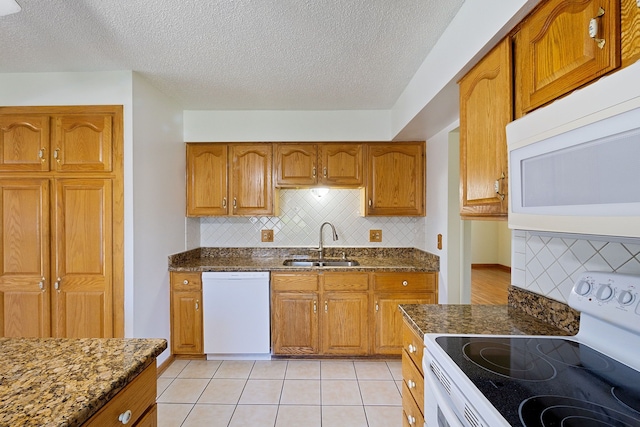 35490 Hatherly Dr, Sterling Heights, MI 48310 - kitchen featuring tasteful backsplash, brown cabinets, a sink, dark stone counters, and white appliances