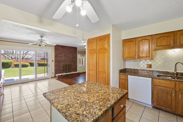 35490 Hatherly Dr, Sterling Heights, MI 48310 - kitchen with a sink, brown cabinets, a ceiling fan, dark stone countertops, and dishwasher