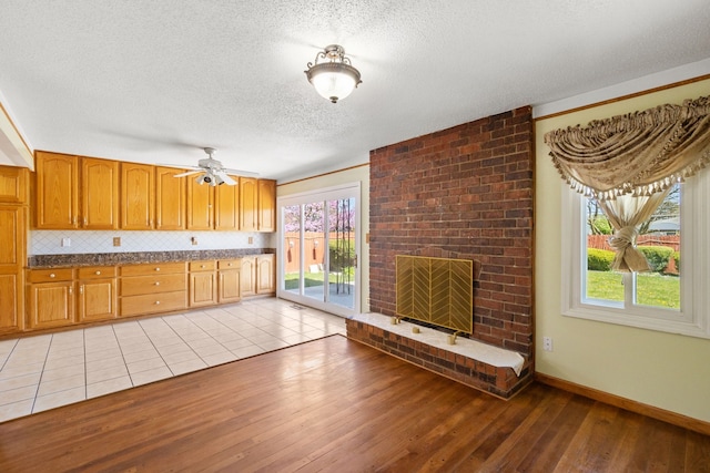 35490 Hatherly Dr, Sterling Heights, MI 48310 - kitchen featuring a healthy amount of sunlight, a ceiling fan, light wood finished floors, and a textured ceiling