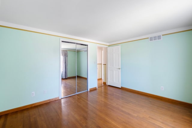 35490 Hatherly Dr, Sterling Heights, MI 48310 - unfurnished bedroom with visible vents, baseboards, wood finished floors, and a closet