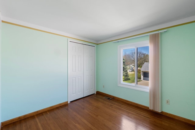 35490 Hatherly Dr, Sterling Heights, MI 48310 - unfurnished bedroom with dark wood-style flooring, baseboards, visible vents, and a closet