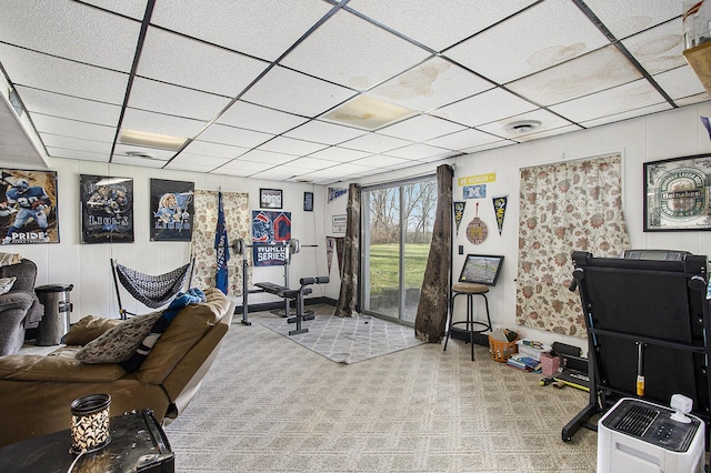interior space with carpet floors, visible vents, and a drop ceiling