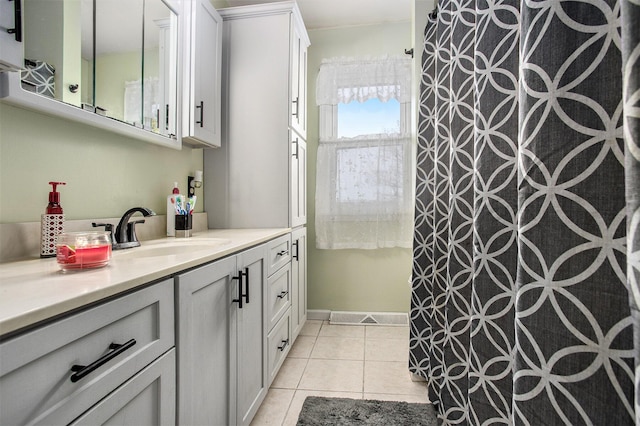 bathroom featuring vanity, tile patterned flooring, and curtained shower
