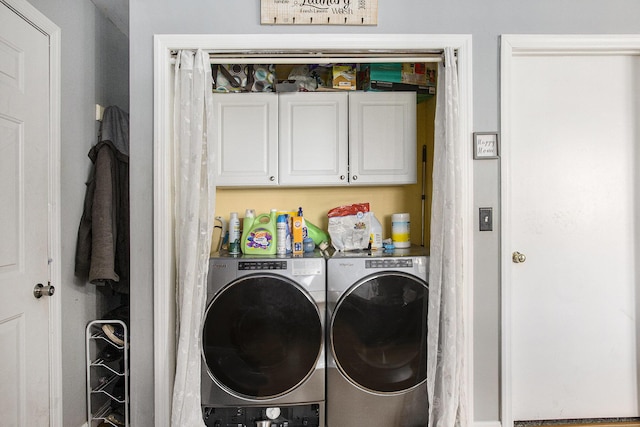 washroom featuring cabinet space and independent washer and dryer