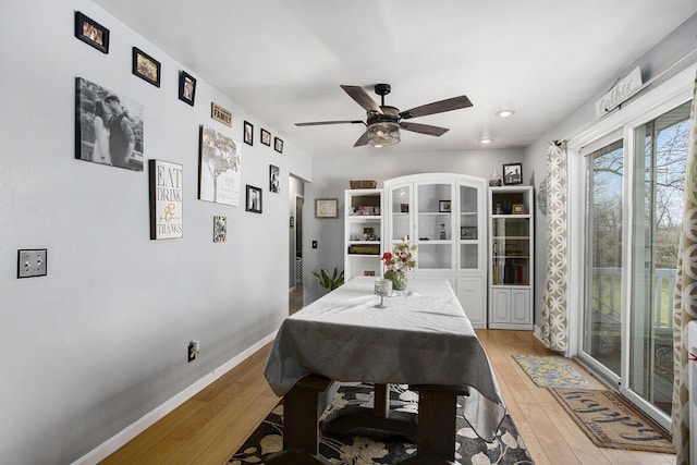 dining room with baseboards, ceiling fan, and light wood-type flooring
