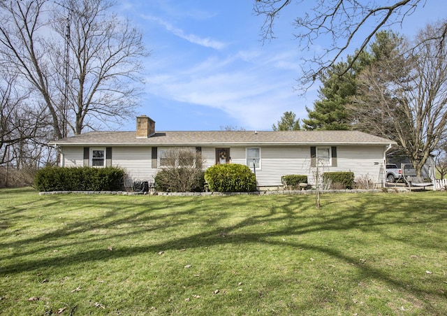 view of front of house featuring a chimney and a front yard