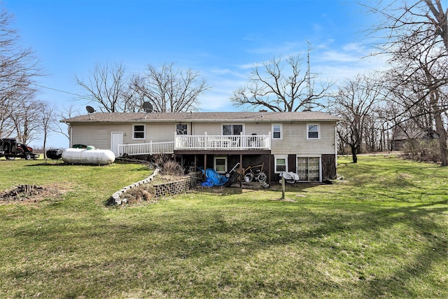 back of house featuring a lawn and a wooden deck