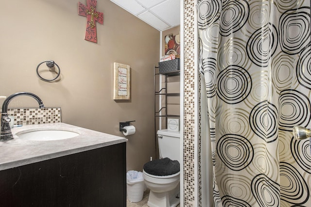 full bathroom featuring vanity, backsplash, and toilet