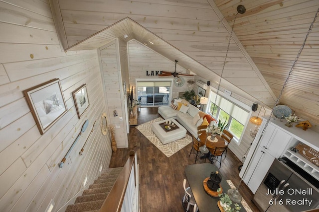 living area featuring wooden walls, wood ceiling, ceiling fan, and hardwood / wood-style floors