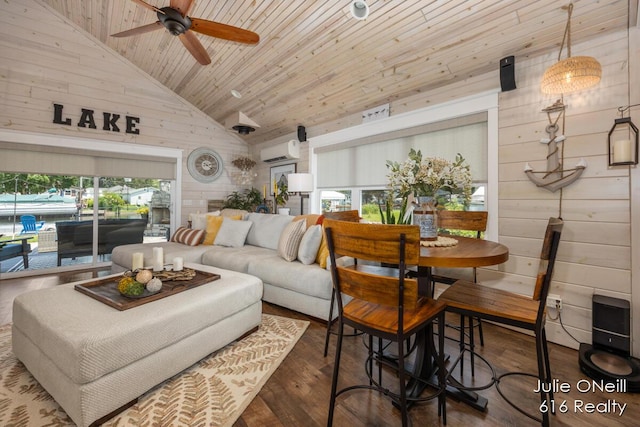 living area with wooden walls, high vaulted ceiling, wooden ceiling, wood finished floors, and a wall mounted AC