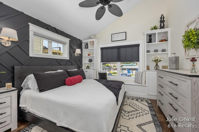 bedroom with ceiling fan, wood finished floors, vaulted ceiling, and multiple windows