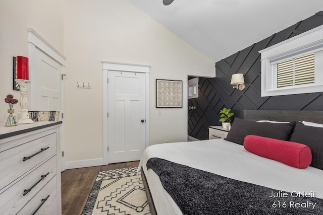 bedroom featuring baseboards, dark wood-style floors, and high vaulted ceiling