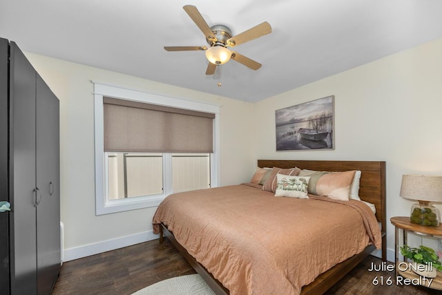 bedroom with a ceiling fan, baseboards, and dark wood finished floors