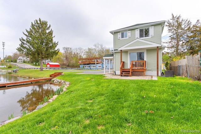 1319 Rochester Rd, Leonard, MI 48367 - rear view of house with cooling unit and a deck with water view