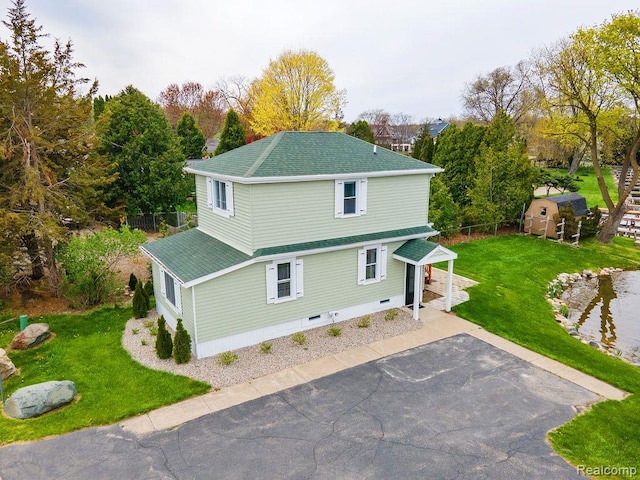 1319 Rochester Rd, Leonard, MI 48367 - view of home's exterior with roof with shingles, driveway, and a patio