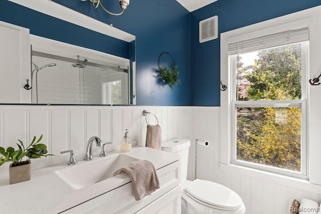 1319 Rochester Rd, Leonard, MI 48367 - full bathroom featuring a shower stall, toilet, vanity, a decorative wall, and a wainscoted wall
