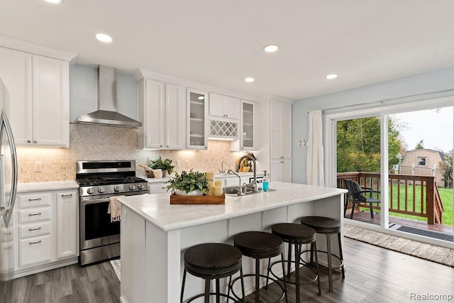 1319 Rochester Rd, Leonard, MI 48367 - kitchen featuring stainless steel gas range, wall chimney exhaust hood, white cabinetry, dark wood-style floors, and backsplash